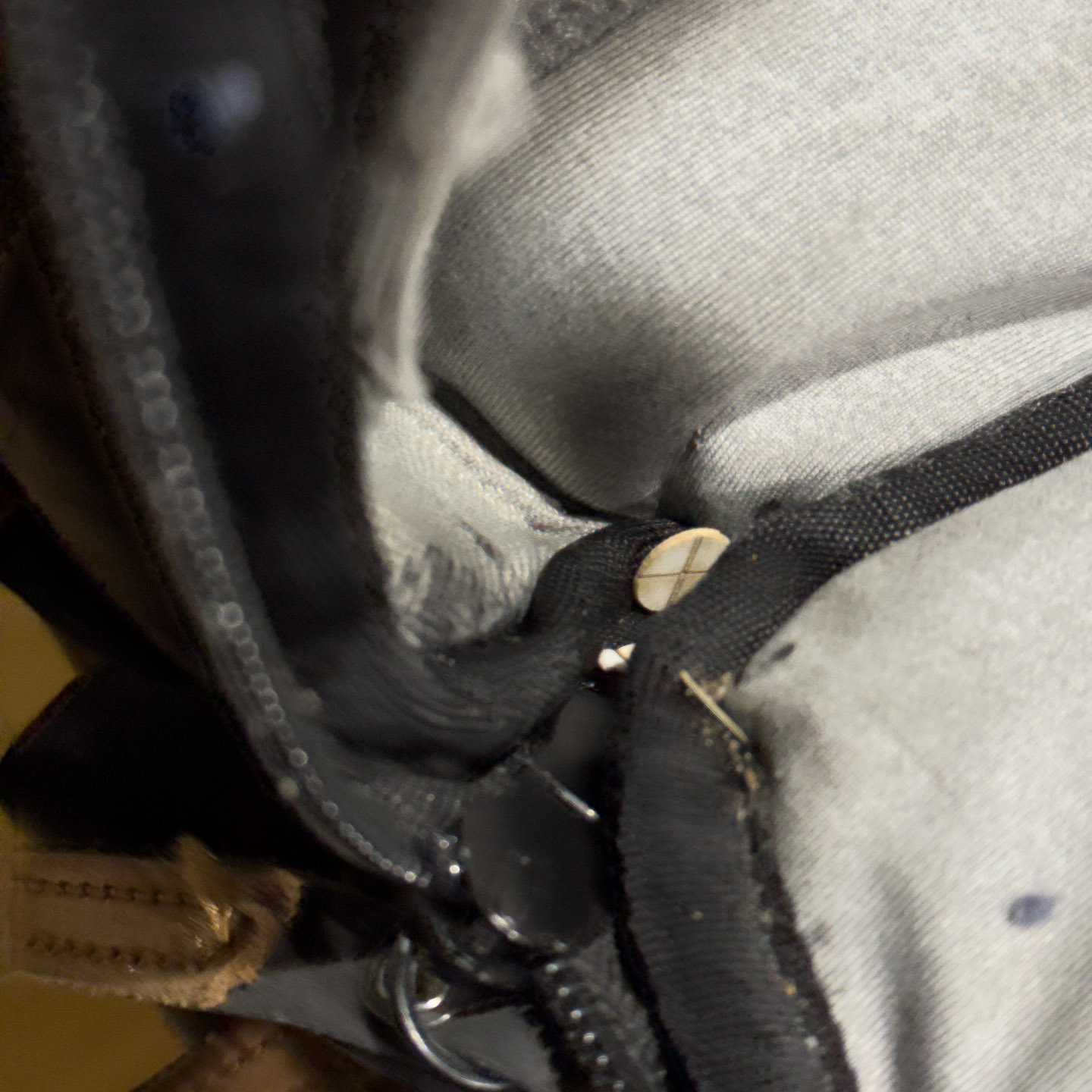 Small paper axle hiding in seam of backpack